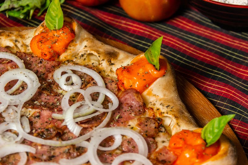 Wood-fired pizza slice with stretchy cheese and caramelized toppings